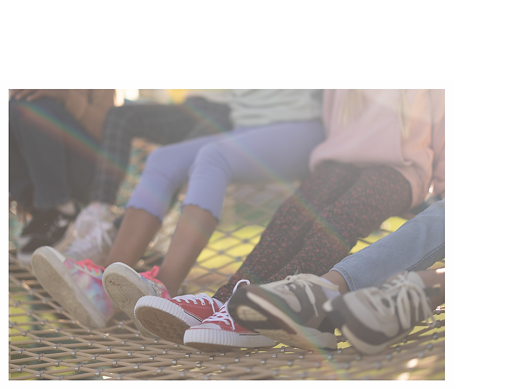 Group of children's legs sitting together on climbing net